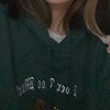 2021 wearing a green hoodie